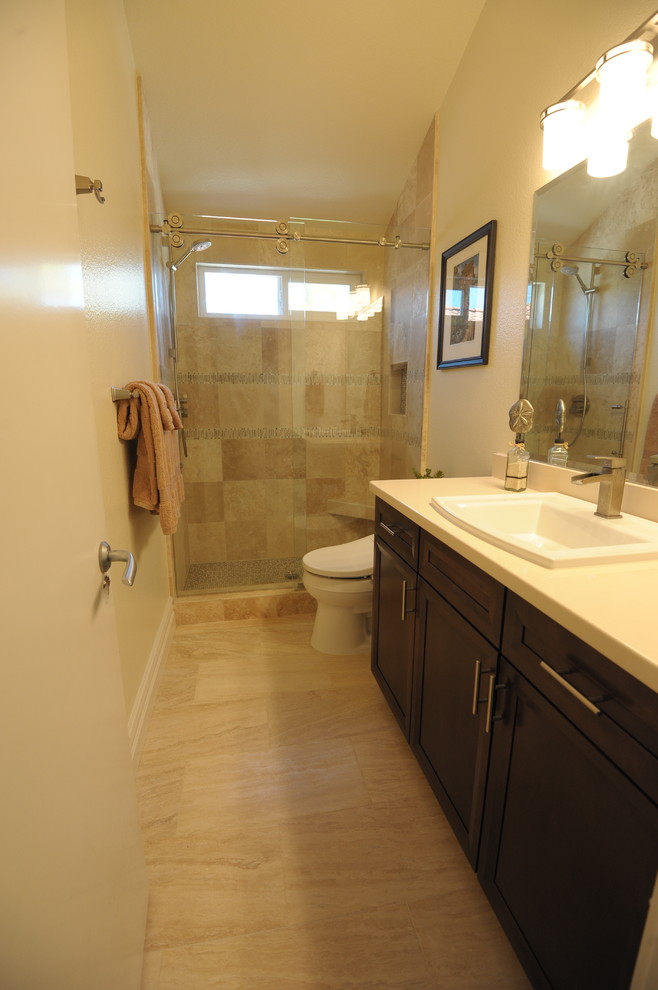 Inspiration for a mid-sized contemporary bathroom in Orange County with a drop-in sink, shaker cabinets, dark wood cabinets, engineered quartz benchtops, a bidet, beige tile, stone slab and travertine floors.
