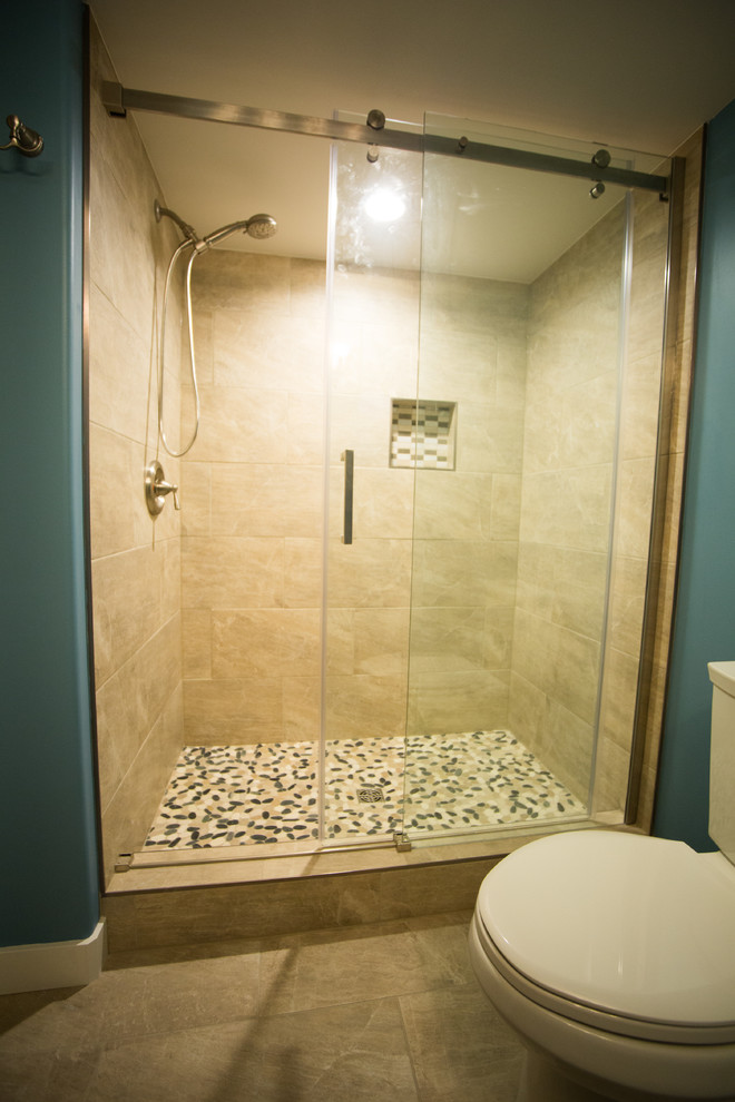 Inspiration for a mid-sized contemporary 3/4 bathroom in Edmonton with an alcove shower, a two-piece toilet, beige tile, ceramic tile, blue walls, ceramic floors, an undermount sink, engineered quartz benchtops, beige floor and a sliding shower screen.