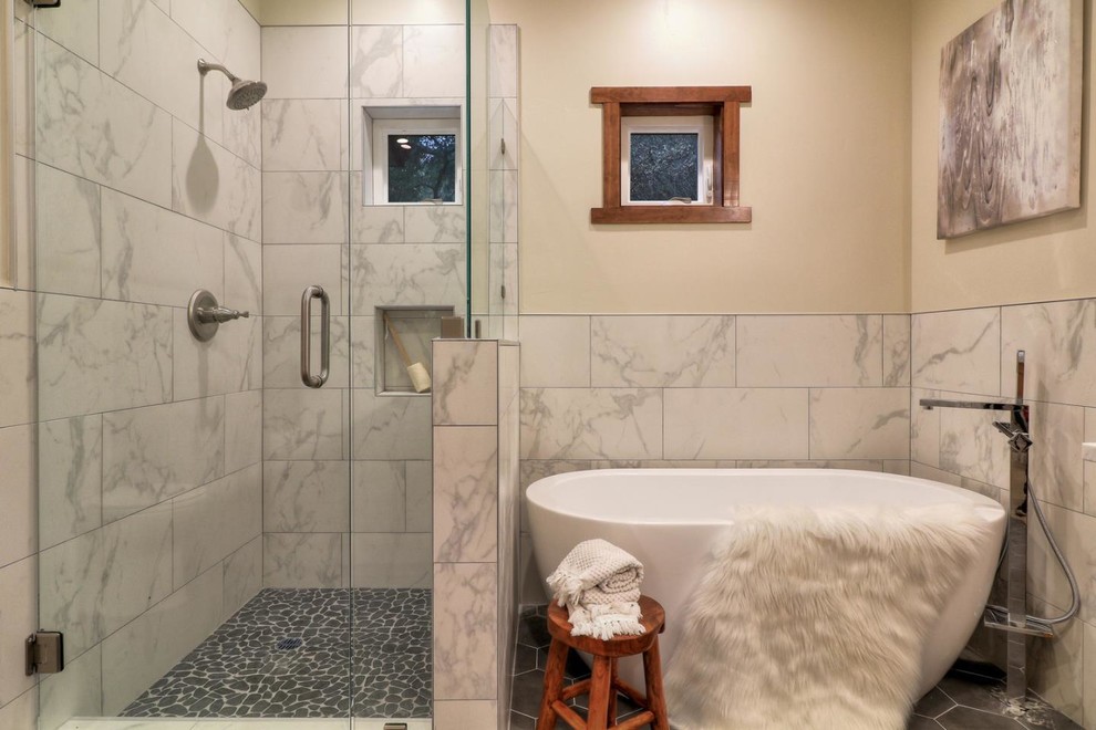 Design ideas for a mid-sized contemporary master bathroom in Other with shaker cabinets, medium wood cabinets, a freestanding tub, a corner shower, a one-piece toilet, black and white tile, subway tile, beige walls, mosaic tile floors, a vessel sink, engineered quartz benchtops, grey floor, a hinged shower door and white benchtops.