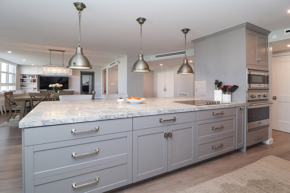 This is an example of a mid-sized traditional galley eat-in kitchen in Miami with grey cabinets and quartzite benchtops.