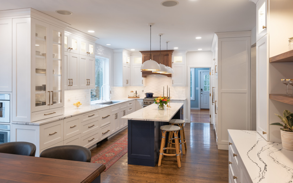 Inspiration for a large u-shaped kitchen/diner in Boston with a single-bowl sink, engineered stone countertops, integrated appliances, medium hardwood flooring and multiple islands.