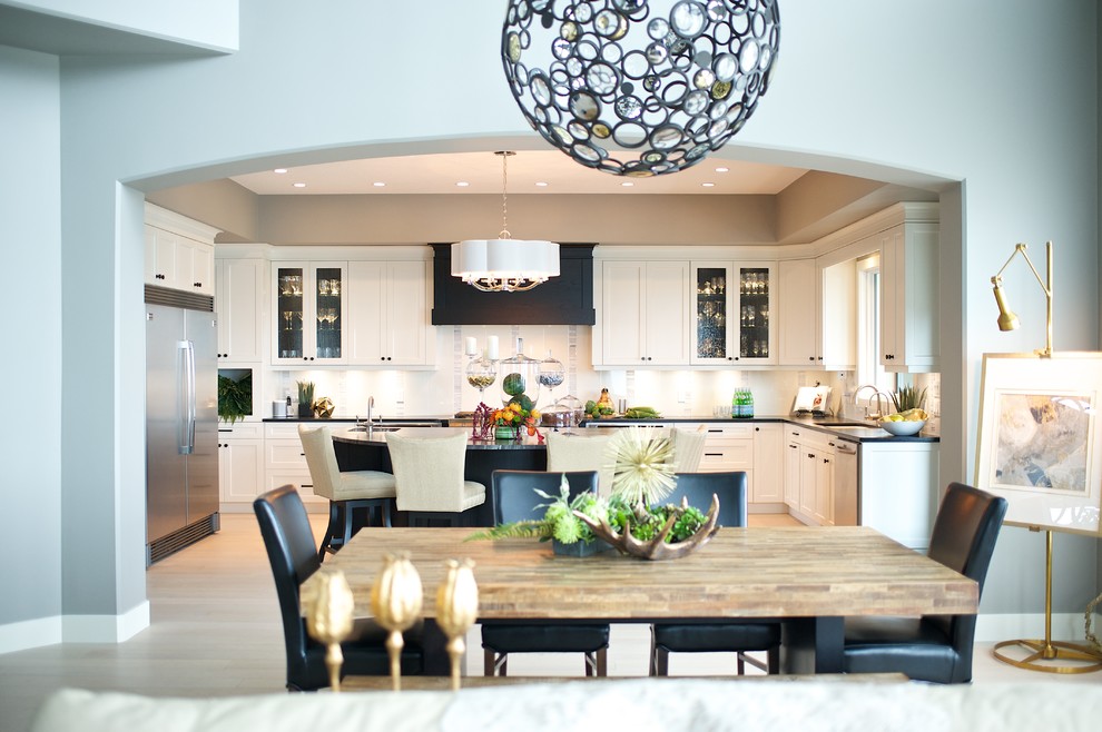 Eat-in kitchen - large transitional u-shaped light wood floor eat-in kitchen idea in Edmonton with shaker cabinets, white cabinets, granite countertops, white backsplash, stone tile backsplash, stainless steel appliances and an island