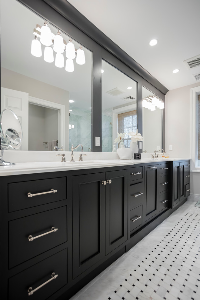 Design ideas for a large transitional master bathroom in Philadelphia with recessed-panel cabinets, black cabinets, black tile, white tile, porcelain tile, white walls, porcelain floors, an undermount sink and solid surface benchtops.