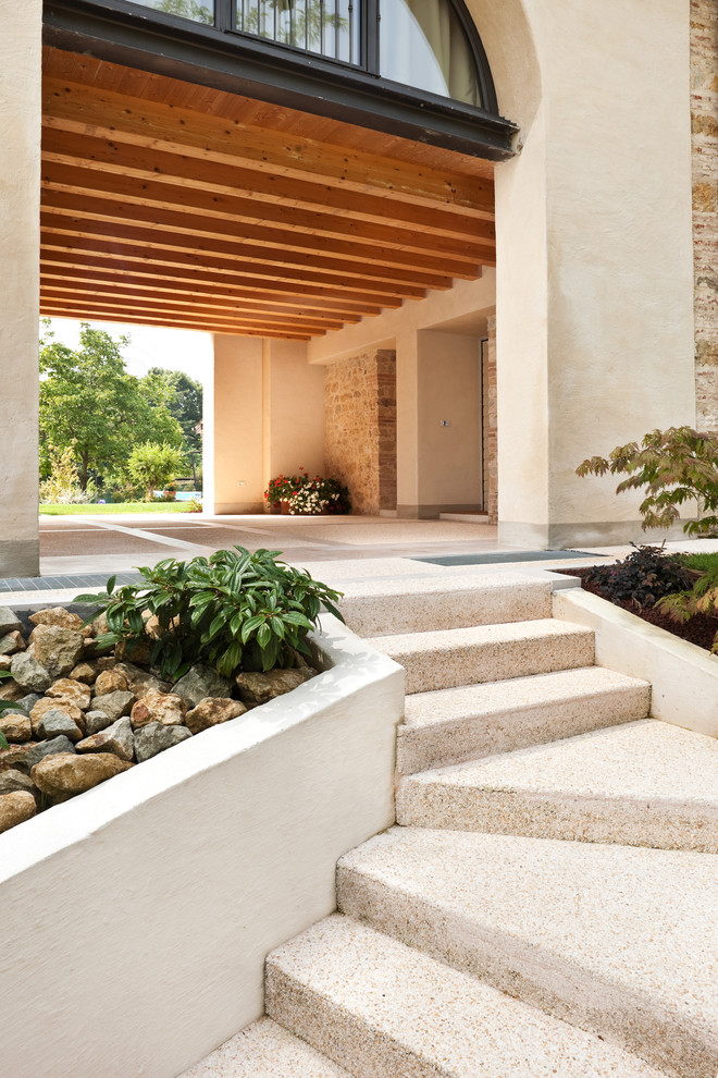 This is an example of a country courtyard garden in Other with concrete pavers.