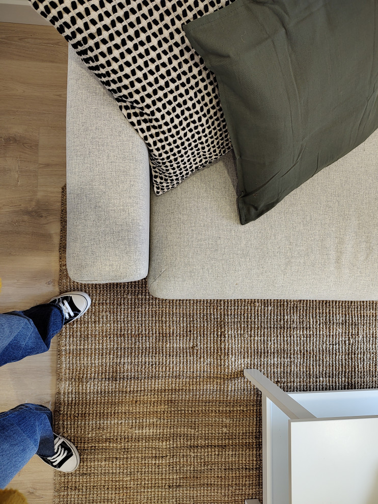 Esempio di un soggiorno scandinavo di medie dimensioni e aperto con pareti bianche, parquet chiaro, TV autoportante, pavimento marrone e tappeto