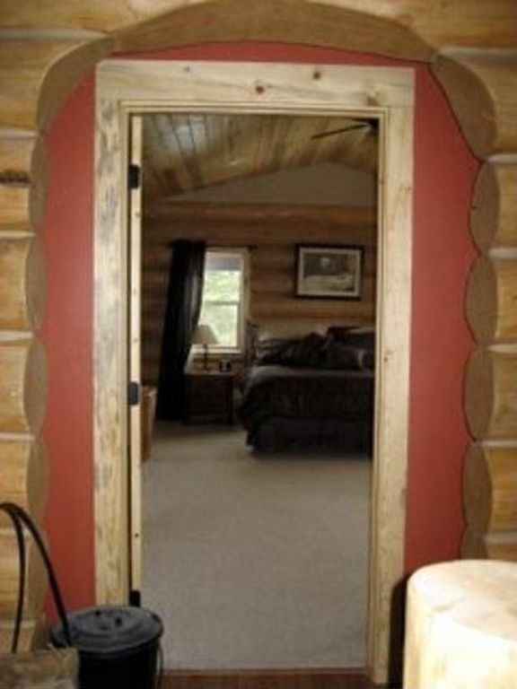 Example of a large mountain style master carpeted bedroom design