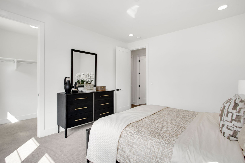 Photo of a large contemporary bedroom in Seattle with white walls, carpet and grey floor.