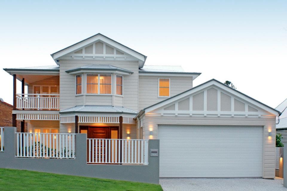 Photo of a large traditional two-storey beige exterior in Brisbane with wood siding and a gable roof.