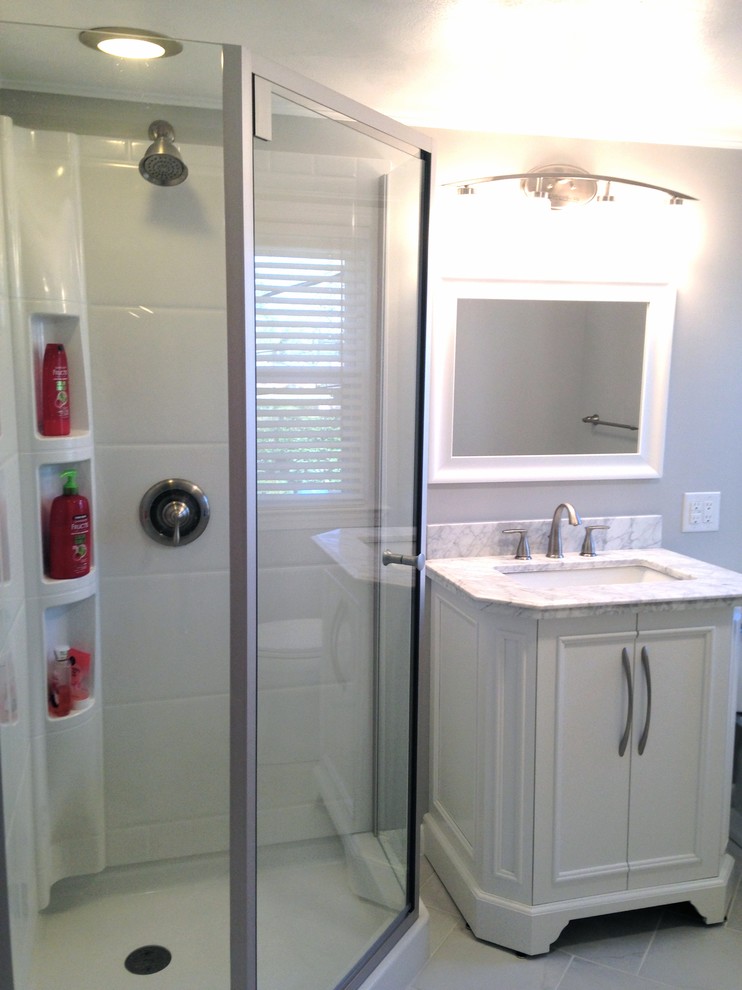 Small transitional 3/4 white tile and porcelain tile porcelain tile home design photo with an integrated sink, a two-piece toilet and white walls