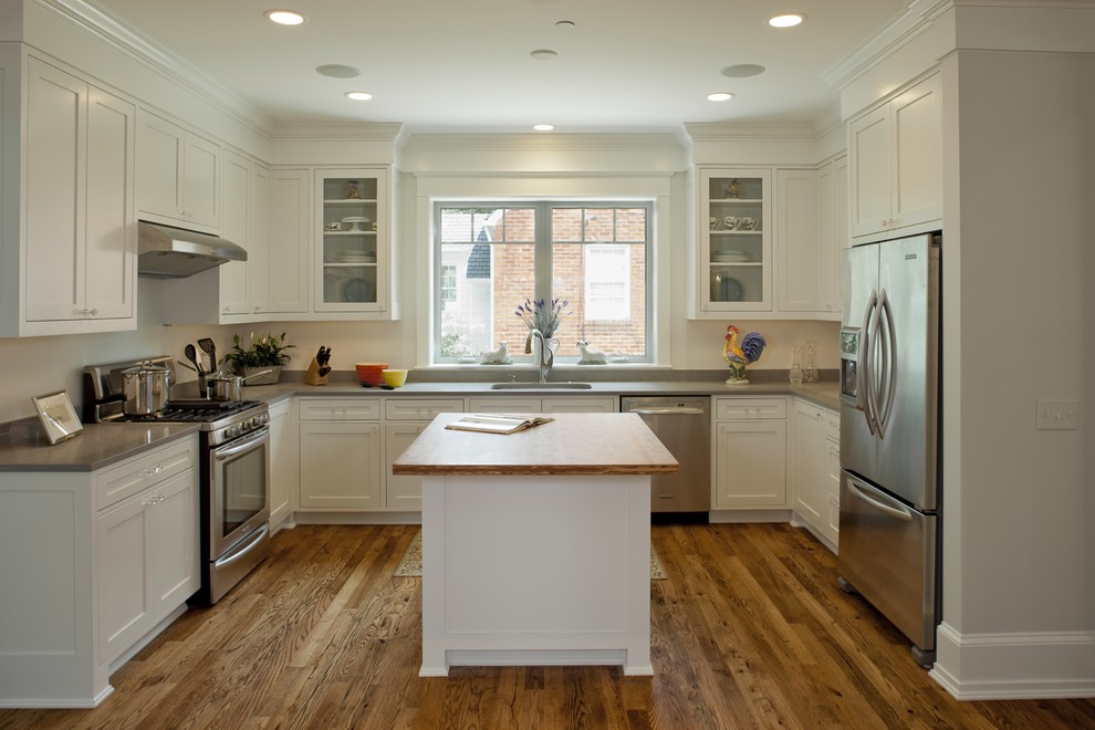 Inspiration for a traditional u-shaped kitchen in DC Metro with stainless steel appliances, shaker cabinets and white cabinets.