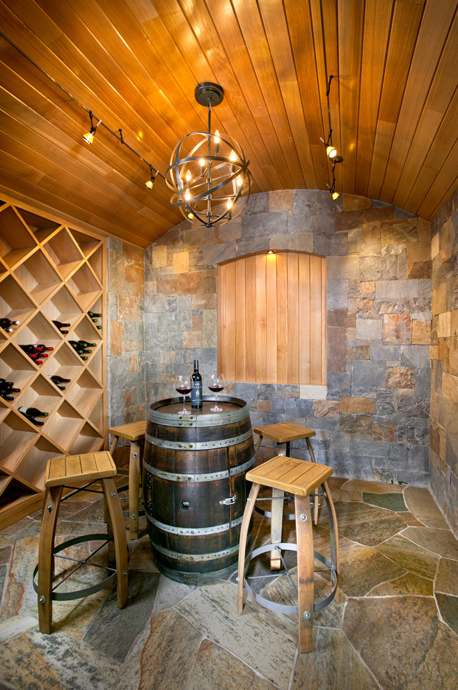 This is an example of a mid-sized mediterranean wine cellar in Atlanta with diamond bins, multi-coloured floor and slate floors.
