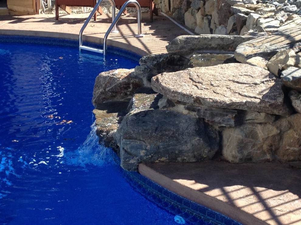 Inspiration for a large backyard stone and custom-shaped pool remodel in Boston