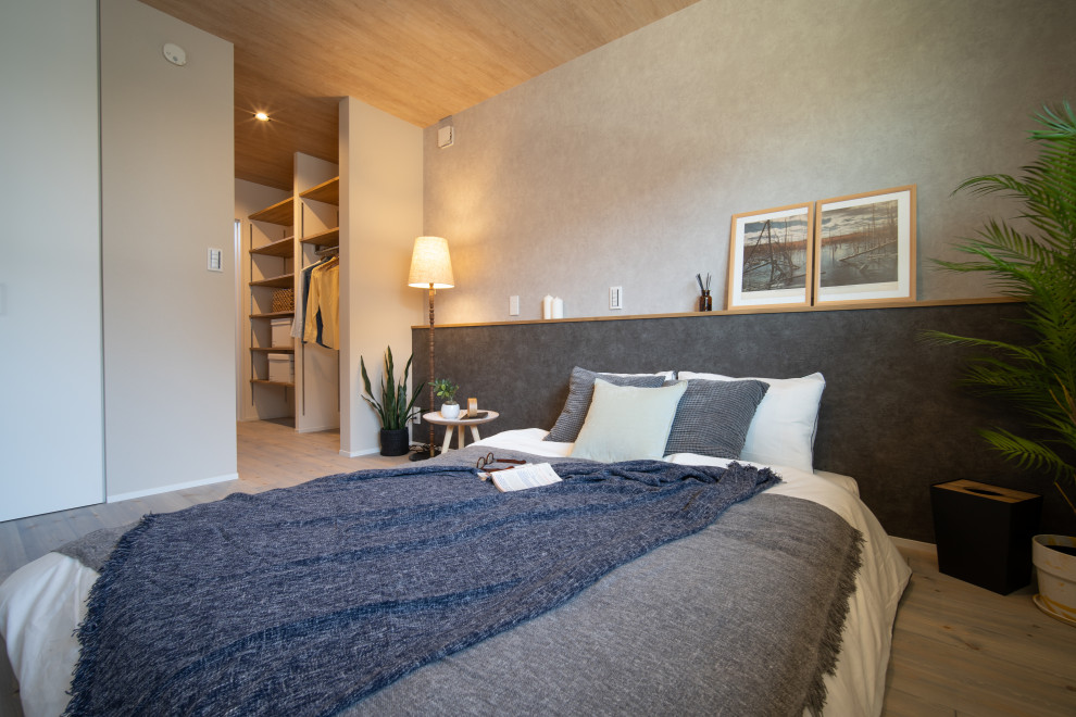 Cette image montre une chambre parentale minimaliste avec parquet clair, un sol gris, un plafond en papier peint et du papier peint.