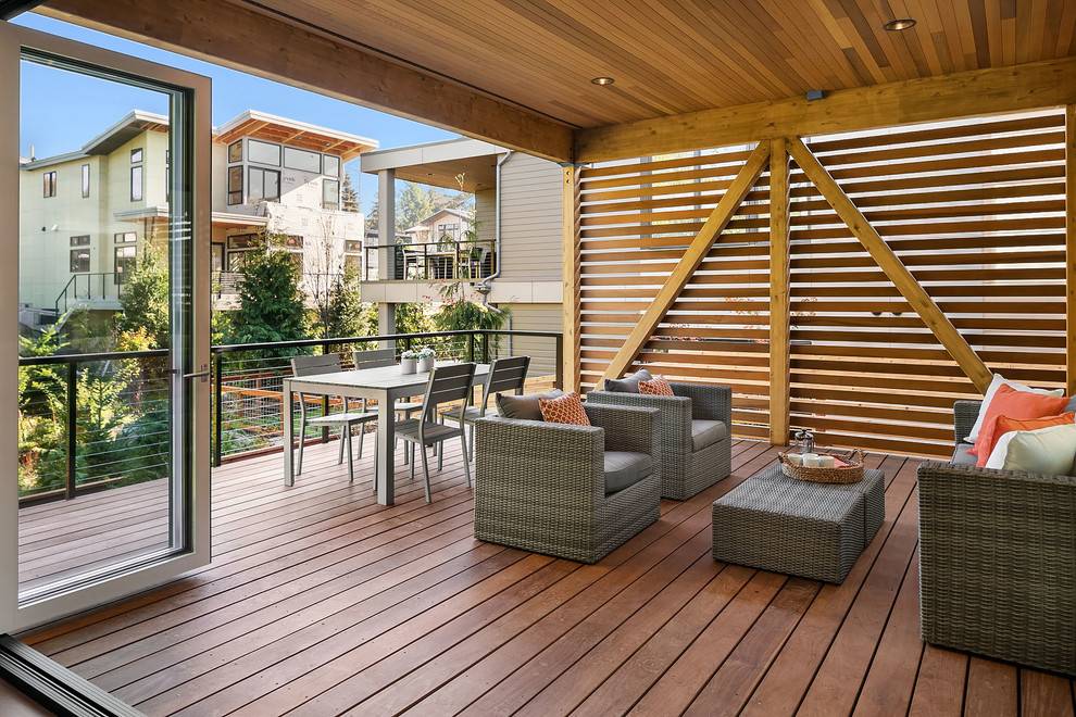 Inspiration for a contemporary backyard deck remodel in Seattle with a roof extension
