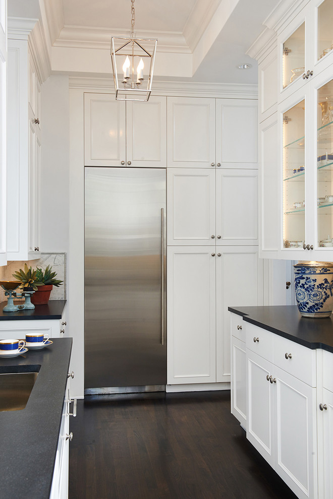 Eat-in kitchen - large transitional dark wood floor eat-in kitchen idea in Los Angeles with an undermount sink, recessed-panel cabinets, white cabinets, granite countertops, white backsplash, stone tile backsplash, stainless steel appliances and an island