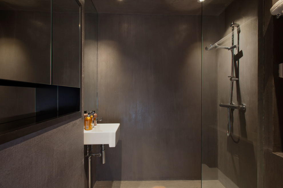 Large contemporary 3/4 bathroom in London with an open shower, a one-piece toilet, gray tile, grey walls, a wall-mount sink, a corner tub and ceramic tile.