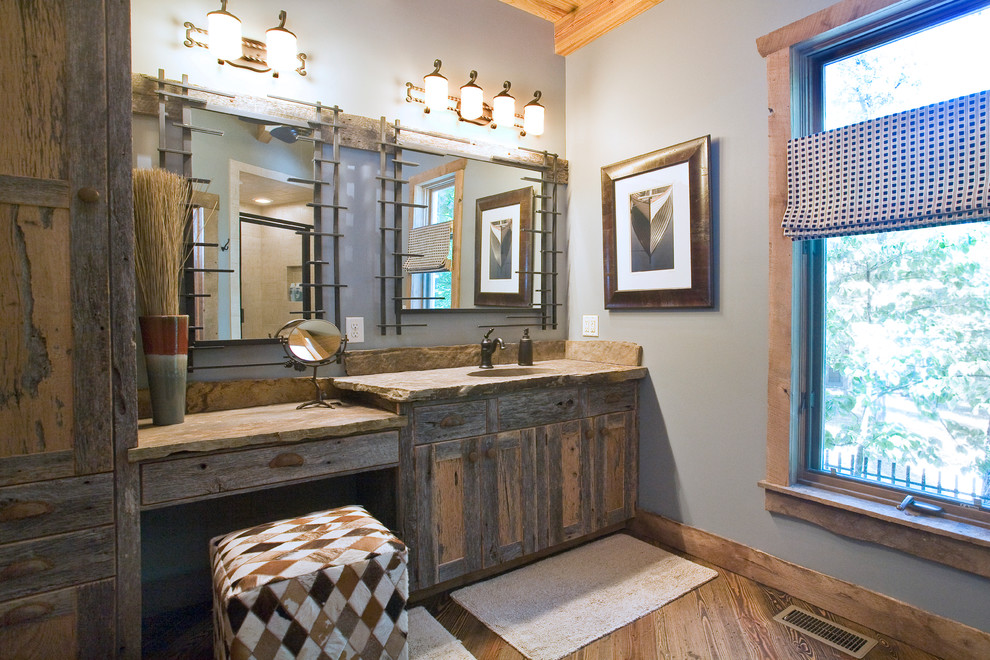 Inspiration for a mid-sized country master bathroom in Little Rock with shaker cabinets, distressed cabinets, blue walls, light hardwood floors, an integrated sink and limestone benchtops.