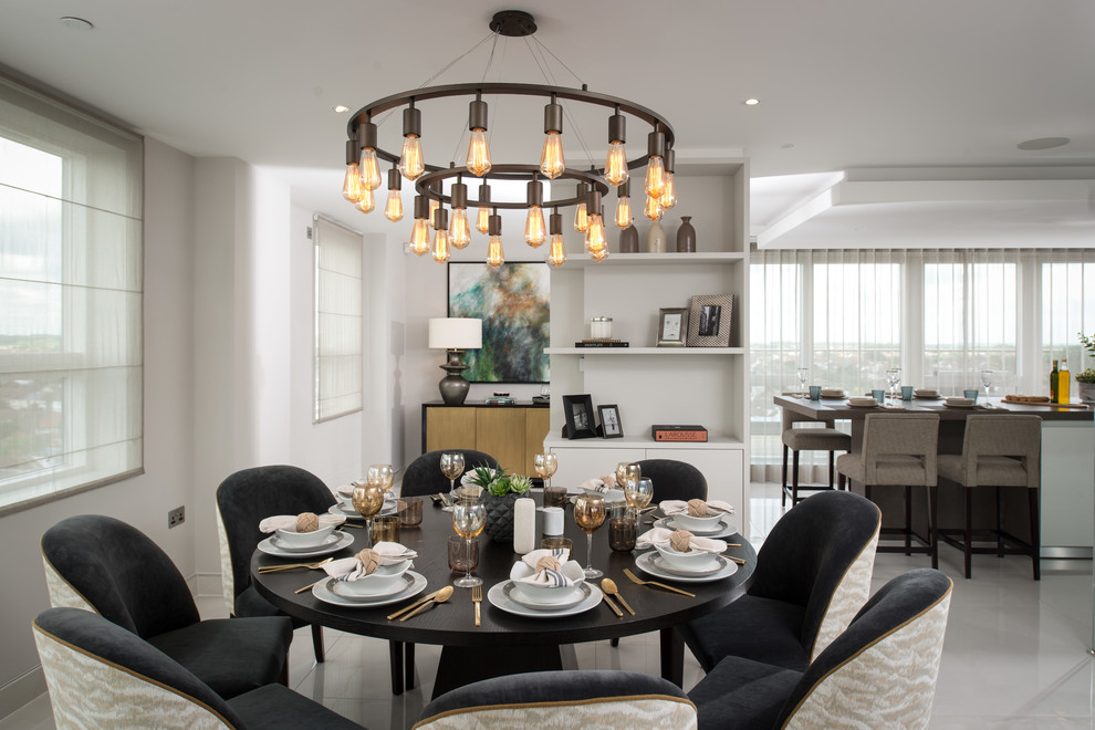 Mid-sized transitional open plan dining in London with white walls, ceramic floors and no fireplace.