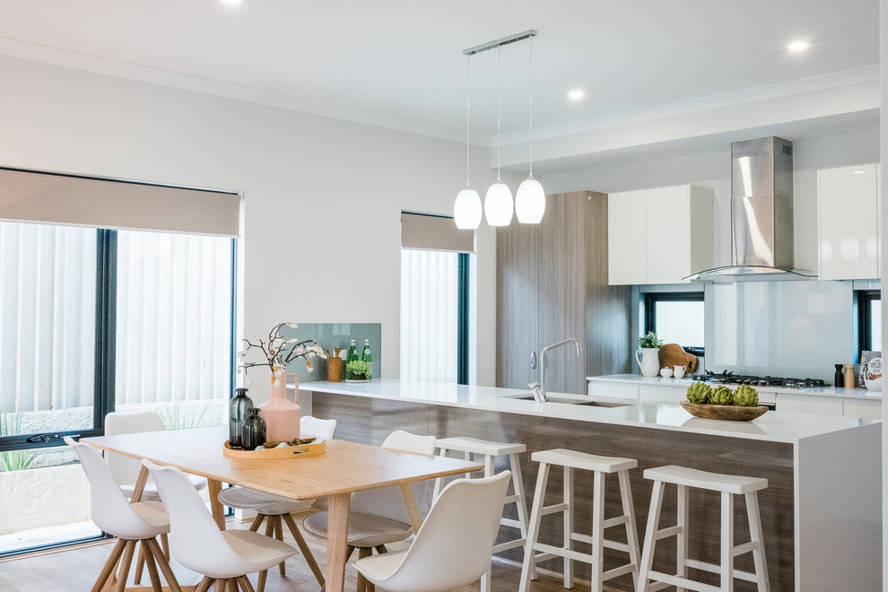 Inspiration for a contemporary kitchen/dining combo in Perth with white walls, light hardwood floors and beige floor.