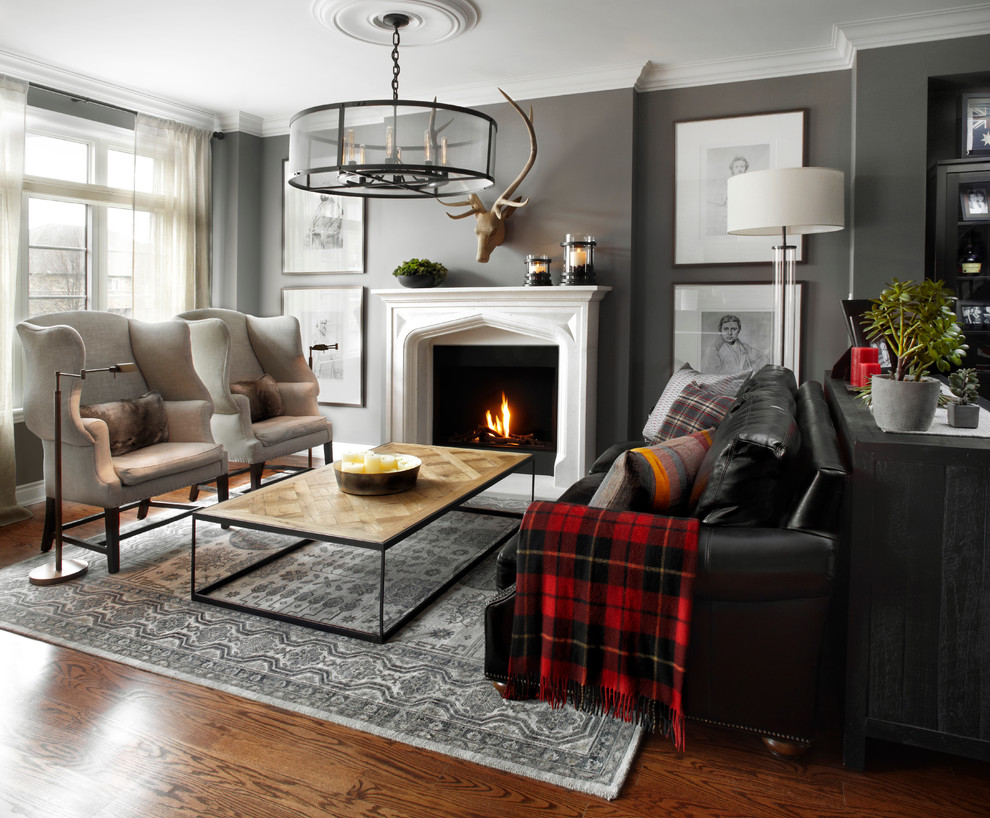 Inspiration for a mid-sized transitional formal open concept living room in Paris with grey walls, medium hardwood floors, a standard fireplace and no tv.
