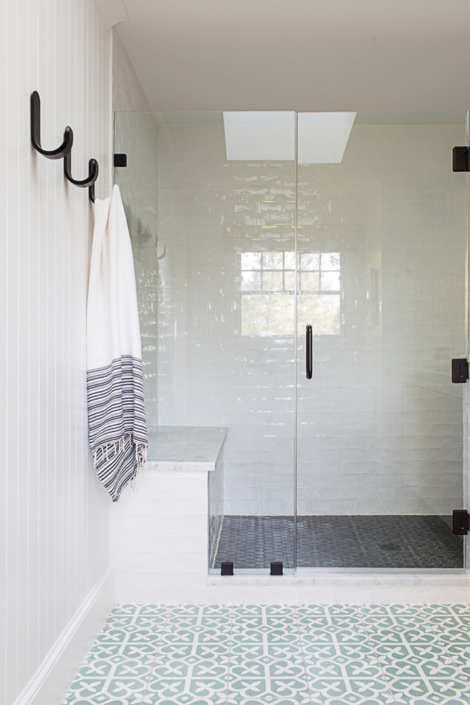 This is an example of a mid-sized transitional master bathroom in New York with flat-panel cabinets, light wood cabinets, an open shower, a two-piece toilet, white tile, ceramic tile, white walls, cement tiles, an integrated sink, concrete benchtops, green floor and a hinged shower door.