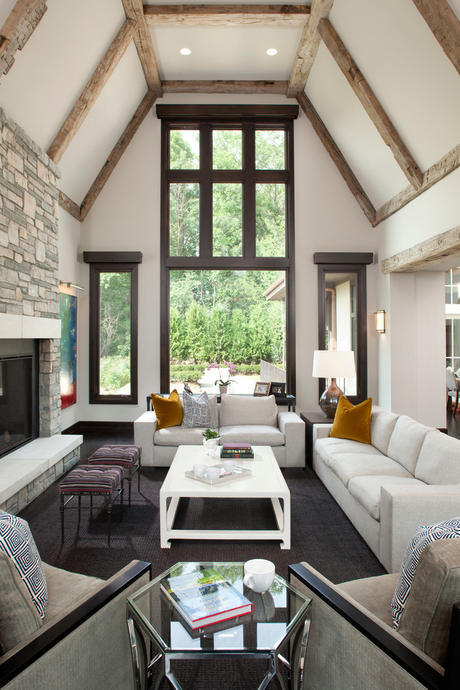 Photo of a transitional formal open concept living room in Minneapolis with white walls, dark hardwood floors, a standard fireplace and a stone fireplace surround.