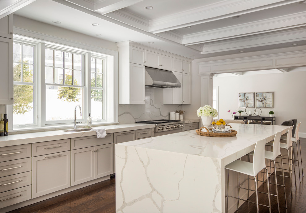 Example of a large transitional galley dark wood floor eat-in kitchen design in Boston with an undermount sink, shaker cabinets, white cabinets, quartz countertops, stone slab backsplash, paneled appliances and an island