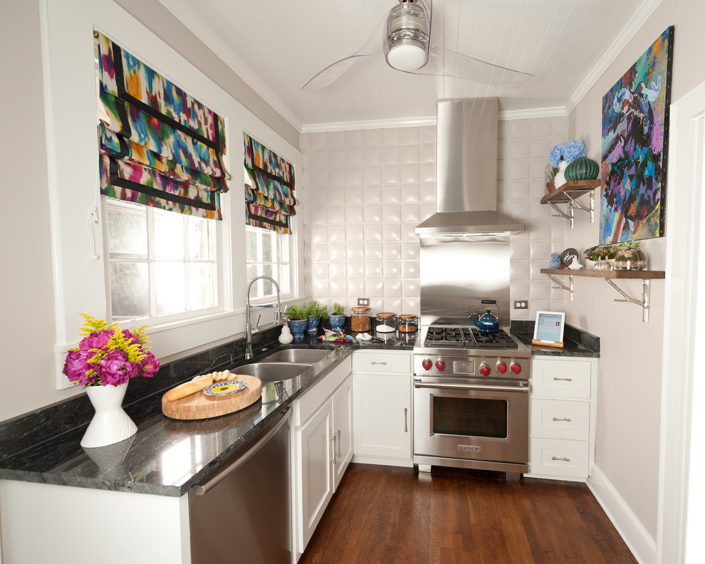 This is an example of a transitional separate kitchen in DC Metro with a double-bowl sink, recessed-panel cabinets, white cabinets, metallic splashback and stainless steel appliances.