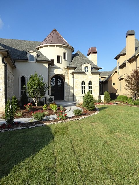 This is an example of a large mediterranean two-storey beige exterior in Other with mixed siding and a hip roof.