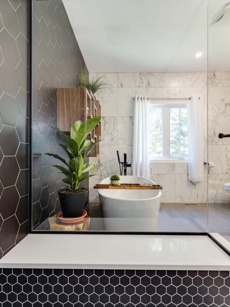 Photo of a large contemporary master bathroom in Ottawa with flat-panel cabinets, medium wood cabinets, a freestanding tub, a corner shower, porcelain tile, porcelain floors, an undermount sink, engineered quartz benchtops, grey floor, a hinged shower door, white benchtops, a shower seat, a single vanity and a freestanding vanity.