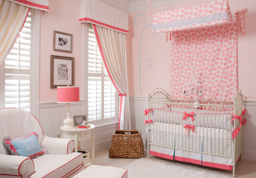 Photo of a mid-sized traditional nursery for girls in Wilmington with pink walls and carpet.