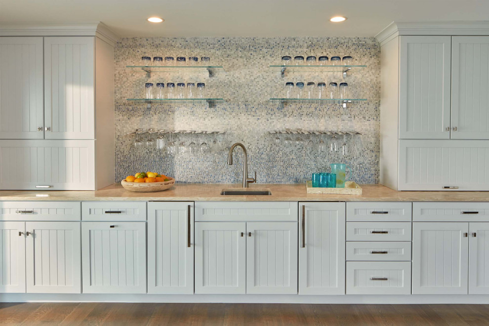 Design ideas for a large beach style single-wall wet bar in Baltimore with an undermount sink, white cabinets, blue splashback, mosaic tile splashback, beige floor and beige benchtop.