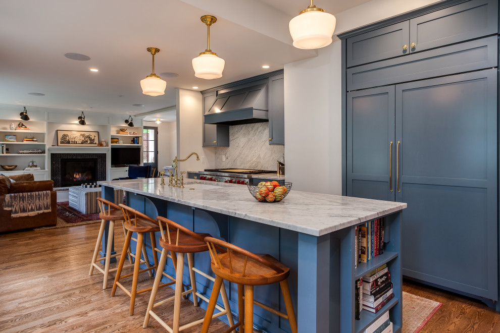 Photo of a large transitional galley open plan kitchen in Denver with an undermount sink, shaker cabinets, blue cabinets, marble benchtops, white splashback, marble splashback, coloured appliances, medium hardwood floors, with island and white benchtop.