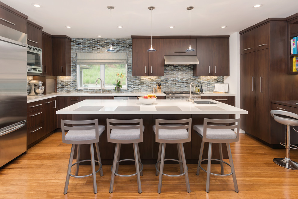 Design ideas for a contemporary u-shaped eat-in kitchen in San Francisco with an undermount sink, flat-panel cabinets, dark wood cabinets, quartz benchtops, grey splashback, ceramic splashback, stainless steel appliances, bamboo floors and with island.