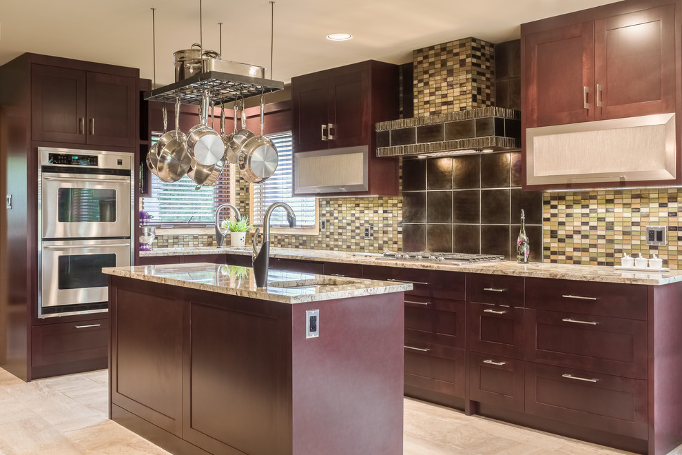 Example of a mid-sized trendy l-shaped ceramic tile and beige floor kitchen design with a double-bowl sink, shaker cabinets, dark wood cabinets, granite countertops, multicolored backsplash, glass tile backsplash, paneled appliances, an island and multicolored countertops