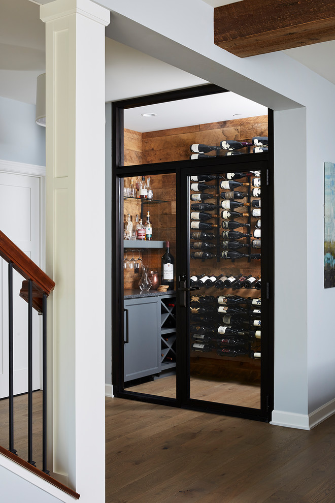 This is an example of a beach style wine cellar in Minneapolis.
