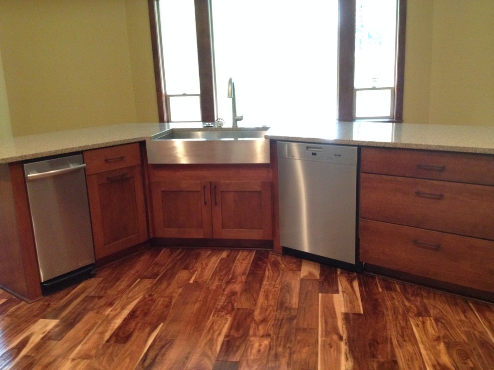 Open concept kitchen - large rustic l-shaped medium tone wood floor open concept kitchen idea with a farmhouse sink, shaker cabinets, medium tone wood cabinets, granite countertops, multicolored backsplash, matchstick tile backsplash, stainless steel appliances and an island
