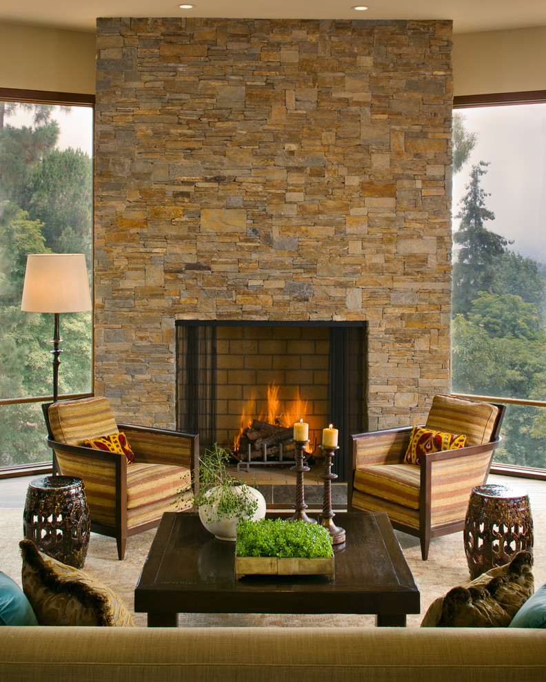 Design ideas for a country living room in Los Angeles with a standard fireplace and a stone fireplace surround.