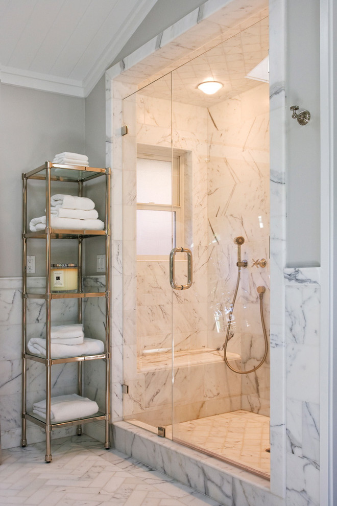This is an example of a traditional bathroom in San Francisco with an alcove shower, white tile, marble floors and marble.