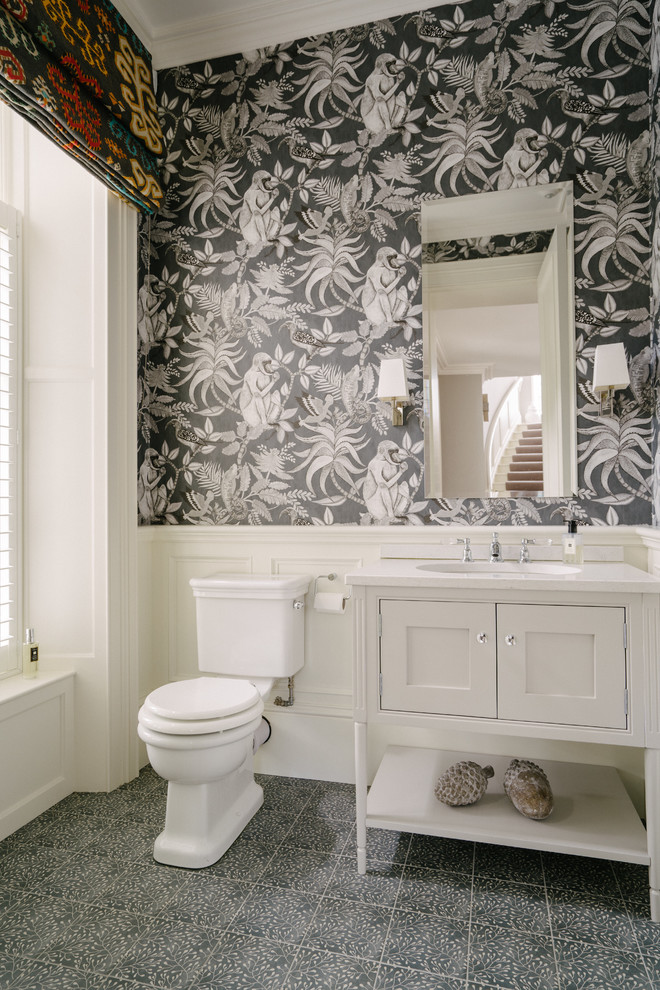 Design ideas for a small transitional powder room in Belfast with white cabinets, porcelain floors, blue floor, beaded inset cabinets, black walls, an undermount sink and white benchtops.