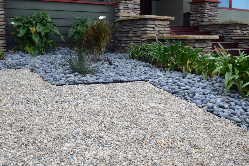 Design ideas for a mid-sized arts and crafts front yard partial sun xeriscape in San Diego with with rock feature and river rock.