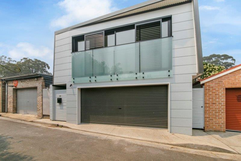 Design ideas for a large contemporary two-storey grey house exterior in Sydney with metal siding, a flat roof and a mixed roof.