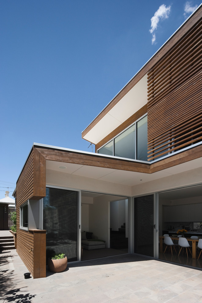 Mid-sized contemporary two-storey exterior in Melbourne with wood siding.