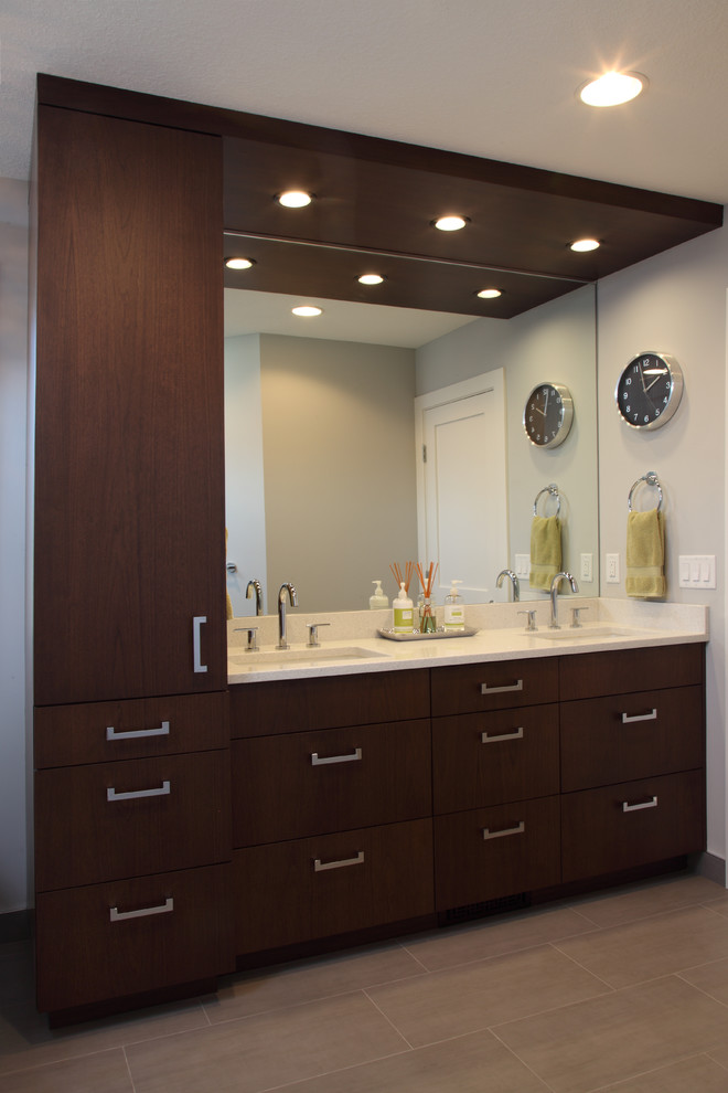 Example of a mid-sized transitional master gray tile and porcelain tile porcelain tile freestanding bathtub design in Minneapolis with flat-panel cabinets, dark wood cabinets, a two-piece toilet, gray walls, an undermount sink and quartz countertops