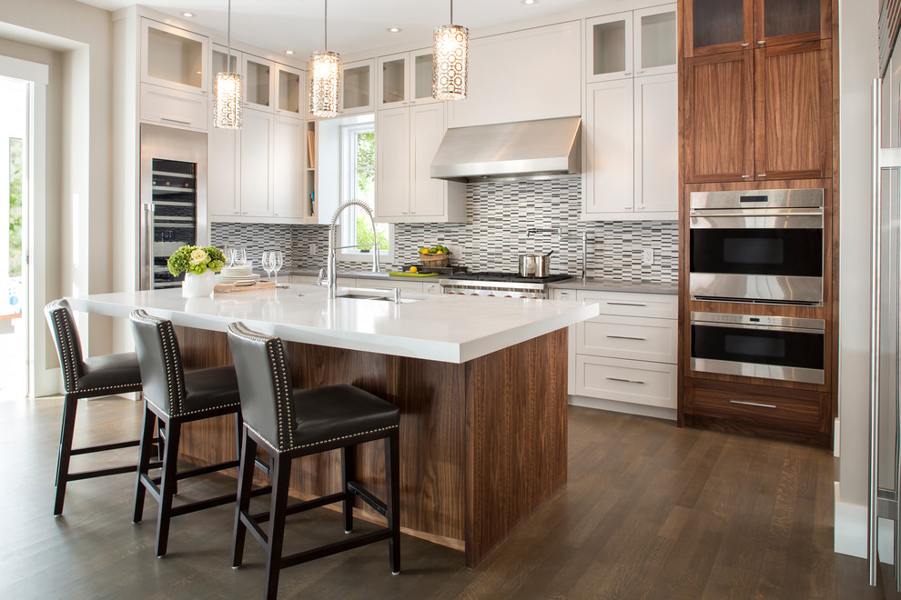 Inspiration for a large transitional l-shaped open plan kitchen in Calgary with an undermount sink, shaker cabinets, white cabinets, quartz benchtops, multi-coloured splashback, matchstick tile splashback, stainless steel appliances, dark hardwood floors and with island.