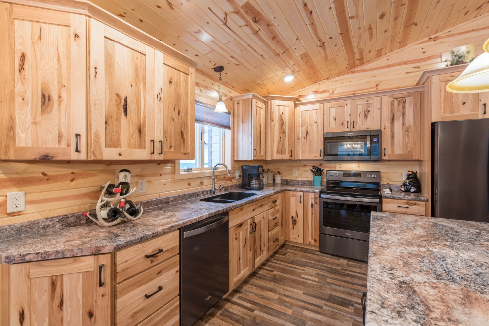 Inspiration for a mid-sized country l-shaped eat-in kitchen in Minneapolis with an undermount sink, shaker cabinets, medium wood cabinets, laminate benchtops, stainless steel appliances, linoleum floors, with island, multi-coloured floor and turquoise benchtop.