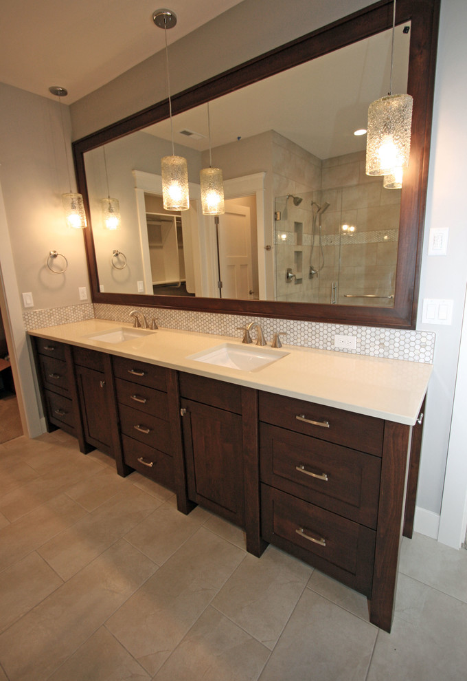 Inspiration for a mid-sized traditional master bathroom in Seattle with shaker cabinets, dark wood cabinets, a freestanding tub, a corner shower, a two-piece toilet, beige tile, porcelain tile, grey walls, porcelain floors, an undermount sink and engineered quartz benchtops.