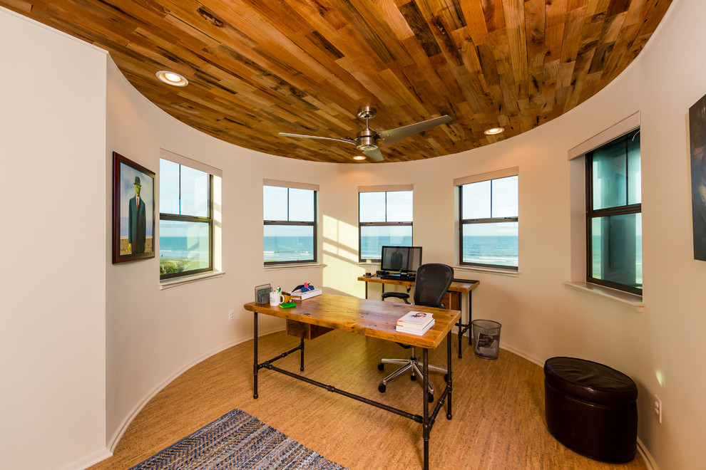 Inspiration for a mid-sized beach style study room in Jacksonville with white walls, cork floors and a freestanding desk.
