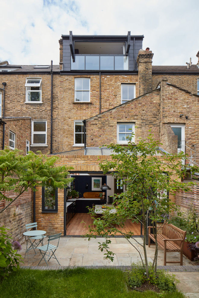 Example of a large eclectic four-story brick exterior home design in London with a tile roof and a blue roof