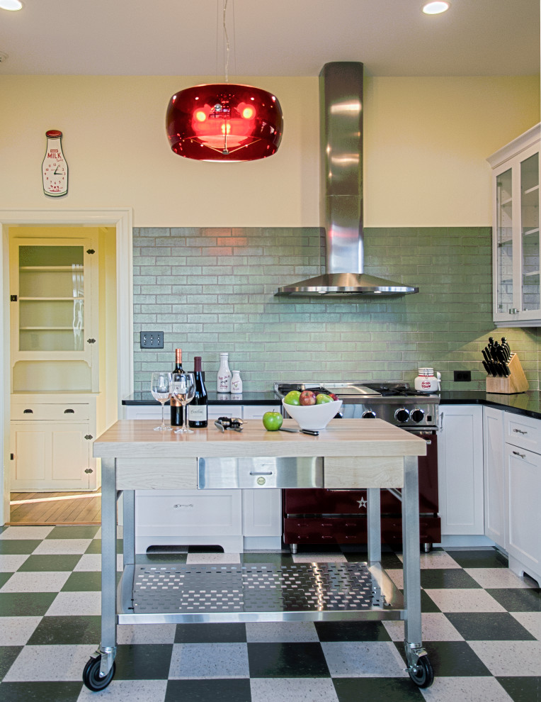 Inspiration for a mid-sized midcentury u-shaped eat-in kitchen in DC Metro with shaker cabinets, white cabinets, quartz benchtops, white splashback, subway tile splashback, coloured appliances, vinyl floors, with island, multi-coloured floor and black benchtop.